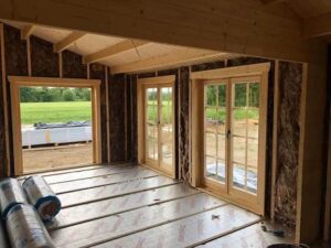 Log Cabin Construction - interior showing floor and wall insulation
