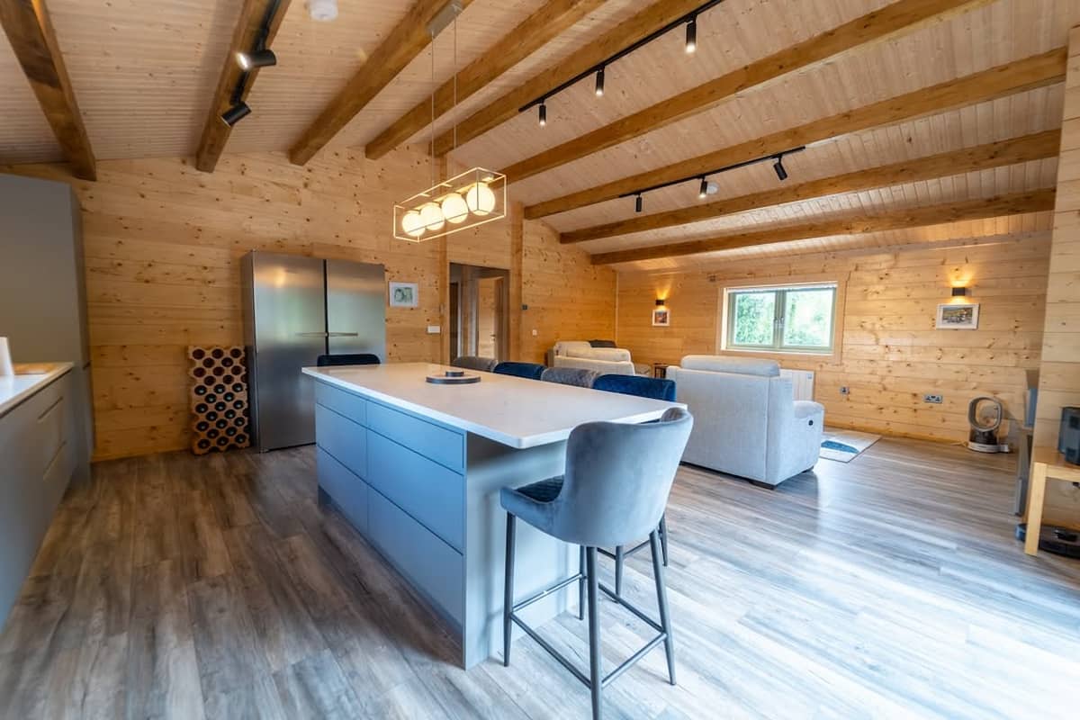 Log Cabins in Ireland – Video Tours & Real Customer Builds 1 a room with a kitchen and a refrigerator