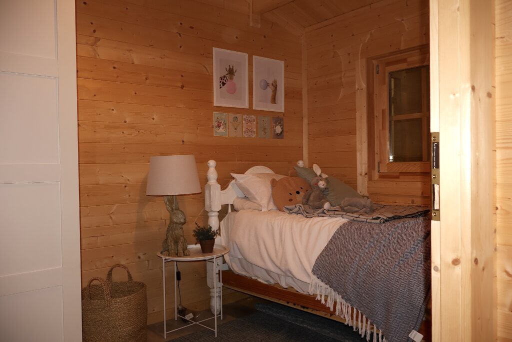 Two bedroom log cabin interior Ireland with timber walls and natural light