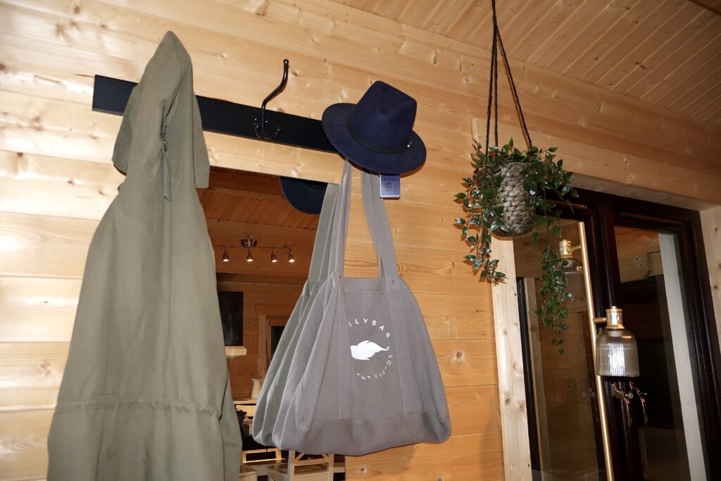 Log cabin hallway interior Ireland with timber walls and hanging storage space